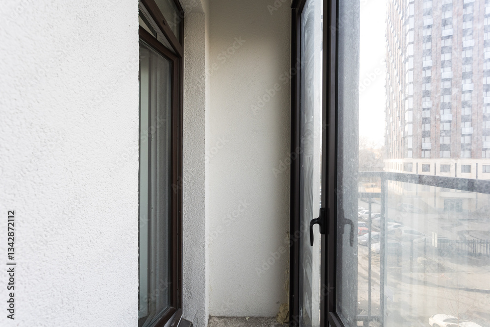 the balcony of an apartment on the upper floors of an apartment building the balcony of an apartment on the upper floors of an apartment building