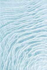 Clear water and waves at sunlight, sun flare and bright white reflections on blue, turquoise water surface. Summer vivid gradient color, graphic nature, dynamic aquatic ripples pattern, aesthetic