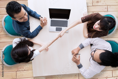 Business people comes to an agreement in a meeting shot from above
