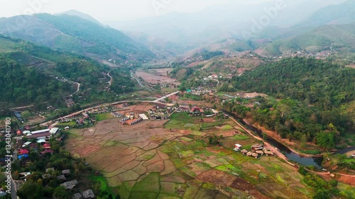 Aerial view of Sapan Village in Mueang Nan District, a hidden gem in Thailand rice field and river in mountains landscape