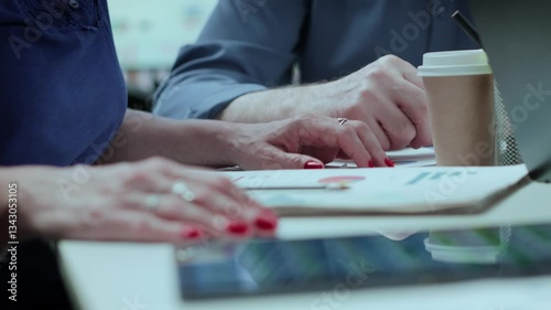 A couple sits around a table discussing financial matters and looking at documents