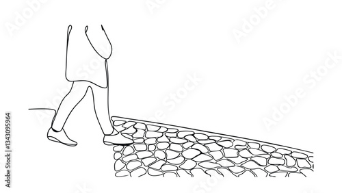 Person walking downhill on uneven cobblestone path street