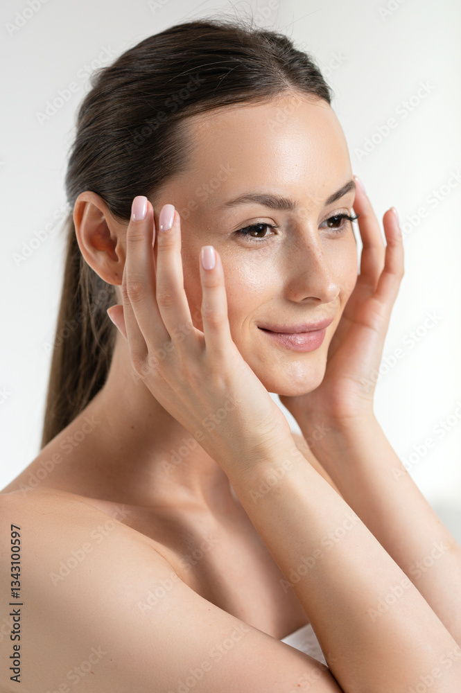Young woman massaging fresh healthy skin on face Young woman massaging fresh healthy skin on face
