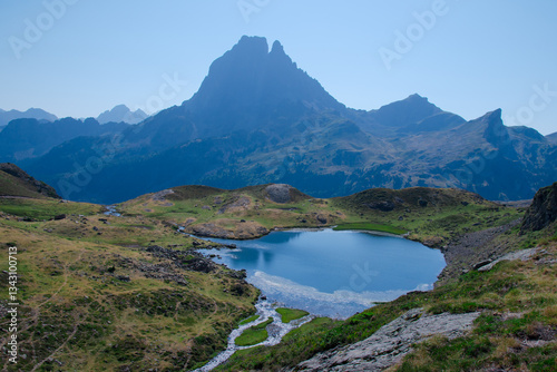 Midi peak Mountain reflection. Ayous lakes. Mountain hiking