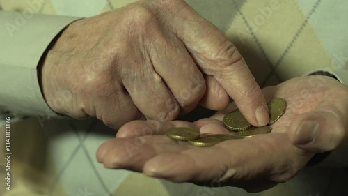 Older man counts euro cents in his hands close-up, pension insurance, poverty