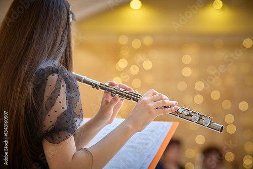 Flute Player Practicing with Sheet Music in Concert Hall. Copy space