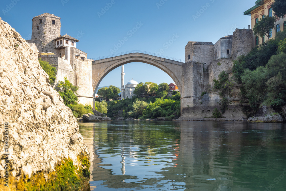 The Stari Most bridge, old bridge on Neretva river in Mostar town, Bosnia and Herzegovina, Europe. Iconic stone arch bridge spans a river with historic towers flanking its sides. The Stari Most bridge, old bridge on Neretva river in Mostar town, Bosnia and Herzegovina, Europe. Iconic stone arch bridge spans a river with historic towers flanking its sides.