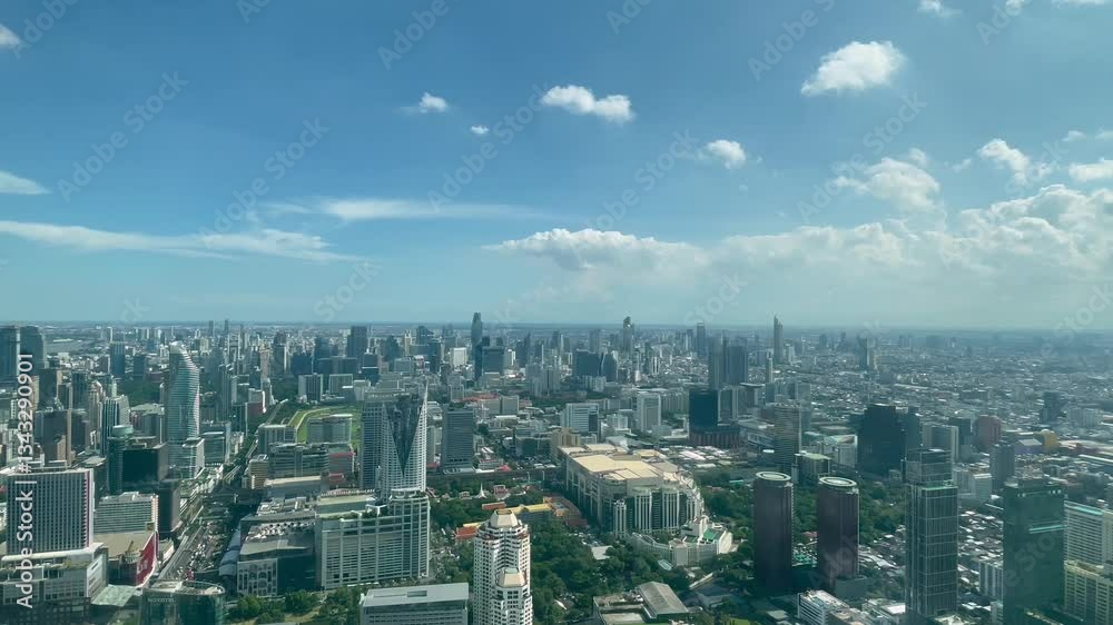 BANGKOK, THAILAND - AUGUST 2024 : Aerial high angle time lapse shot of Bangkok city in sunny daytime. 4K shot of buildings and streets around downtown Siam area. BANGKOK, THAILAND - AUGUST 2024 : Aerial high angle time lapse shot of Bangkok city in sunny daytime. 4K shot of buildings and streets around downtown Siam area.