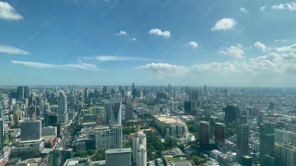 BANGKOK, THAILAND - AUGUST 2024 : Aerial high angle time lapse shot of Bangkok city in sunny daytime. 4K shot of buildings and streets around downtown Siam area. BANGKOK, THAILAND - AUGUST 2024 : Aerial high angle time lapse shot of Bangkok city in sunny daytime. 4K shot of buildings and streets around downtown Siam area.