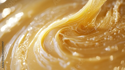 A smooth, golden paste of granular film wax, ready for application, promising a clean and effective depilation experience.