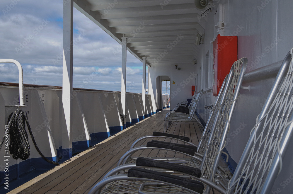 Outdoor balcony terrace veranda deck patio with aluminium chairs sun loungers onboard classic cruiseship cruise ship liner