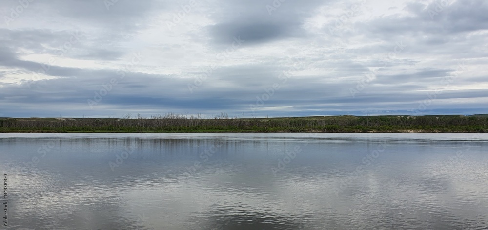 Autumn steppe landscape with golden grass, the calm Don River, and colorful foliage under a cloudy sky. Autumn steppe landscape with golden grass, the calm Don River, and colorful foliage under a cloudy sky.