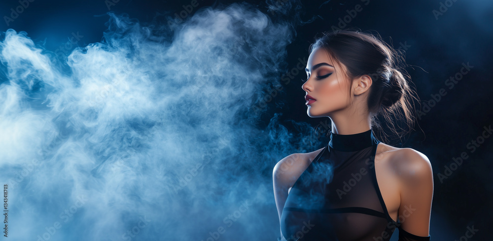 Obraz premium woman in sheer black outfit poses confidently against smoky, dark background, exuding elegance and mystery. Her hair is styled in sleek bun, enhancing her poised demeanor