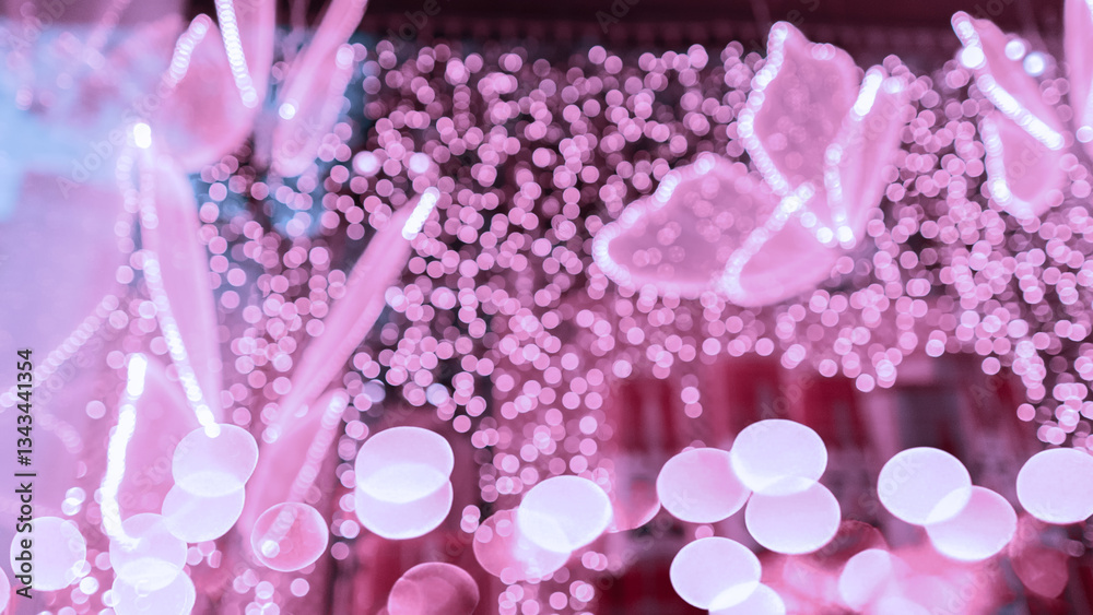 Pink bokeh lights creating butterfly shapes with ethereal motifs in blurred background