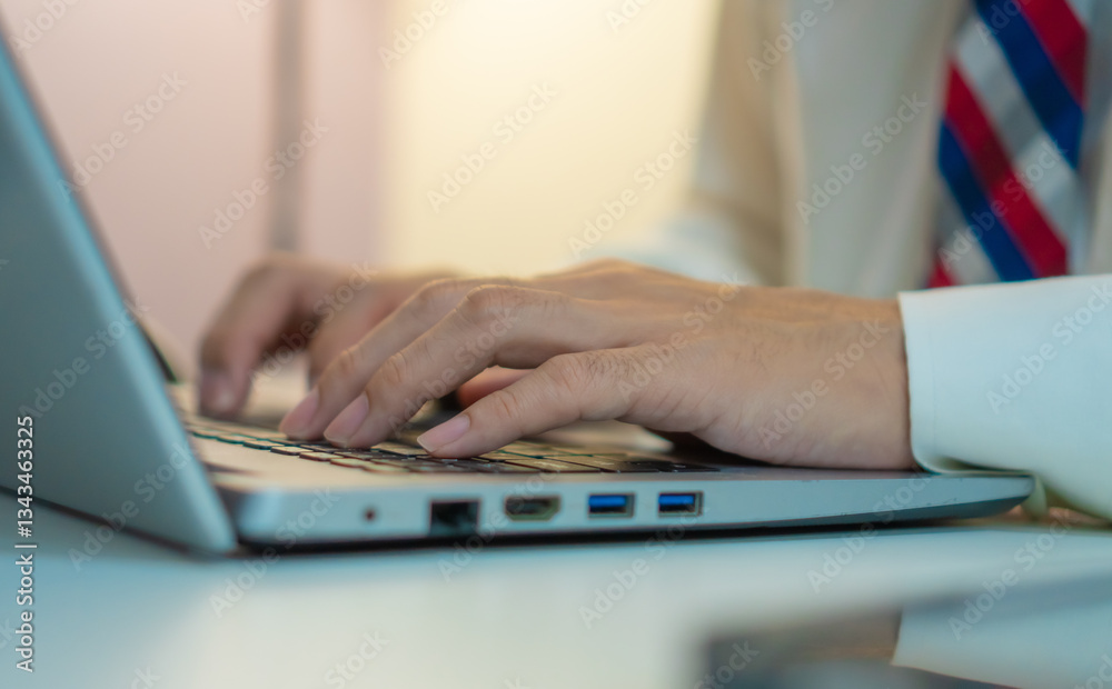close up of person typing on laptop keyboard, wearing formal suit and tie, in professional office setting. image conveys focus and productivity close up of person typing on laptop keyboard, wearing formal suit and tie, in professional office setting. image conveys focus and productivity