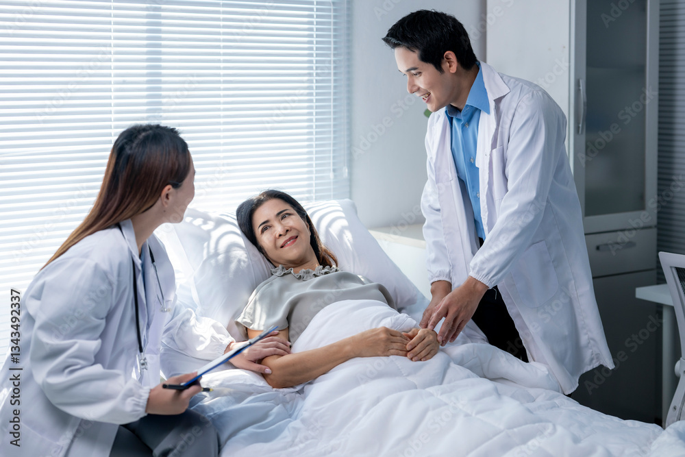 Fototapeta premium A woman is in a hospital bed with two doctors standing over her