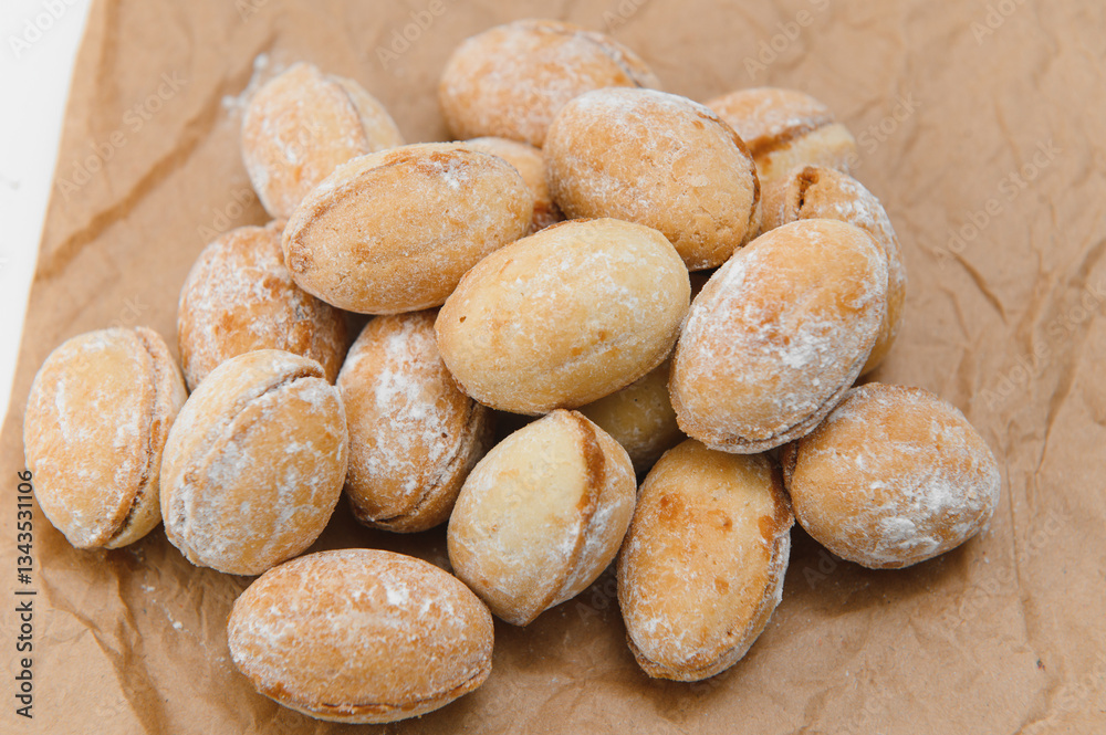 Delicious nut shaped cookies with boiled condensed milk on white background Delicious nut shaped cookies with boiled condensed milk on white background