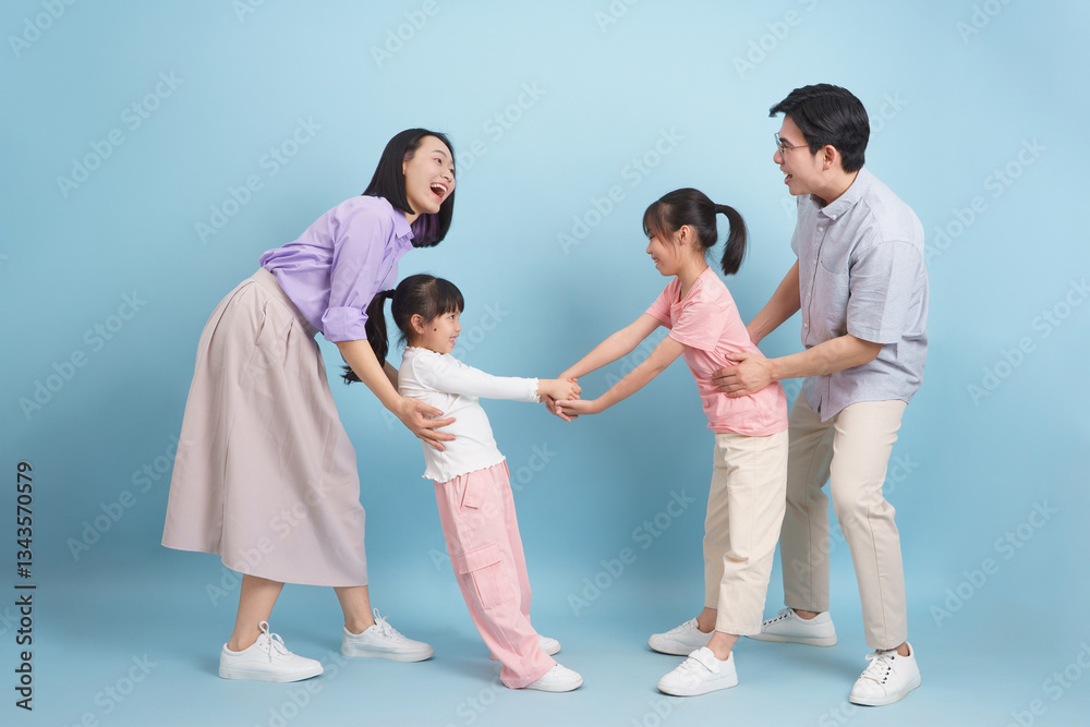 Family enjoying playful interaction in a light and cheerful indoor setting with two children and their parents in casual clothing Family enjoying playful interaction in a light and cheerful indoor setting with two children and their parents in casual clothing
