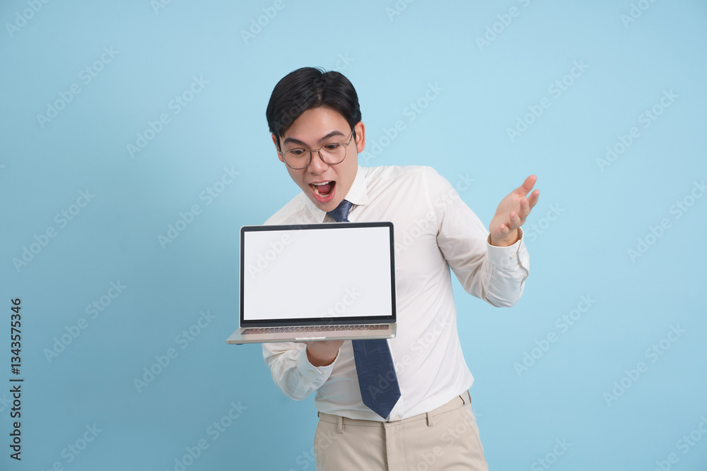 Young Asian professional presenting a laptop with enthusiasm in a simple studio environment in a modern setting Young Asian professional presenting a laptop with enthusiasm in a simple studio environment in a modern setting
