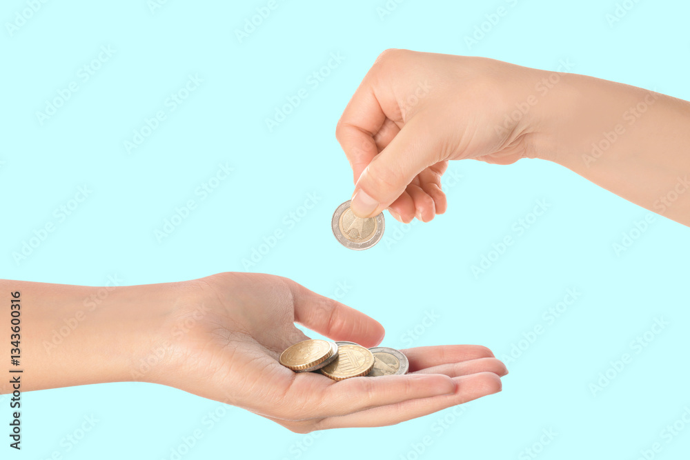 Sponsor offering coins to woman on light blue background, closeup Sponsor offering coins to woman on light blue background, closeup