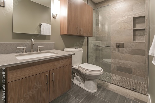 Modern bathroom with contemporary style.  Features a vanity, toilet, walk-in shower, and minimalist design