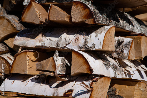Birch firewood. A stack of birch logs chopped into four pieces. Firewood for the stove.