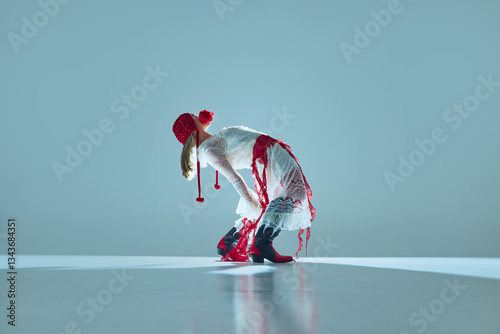 Young woman in white lace dress, red tights, and bonnet bends backward in surreal pose, symbolizing fluidity of identity and transformation. Concept of fashion, movement, avant-garde art, beauty.