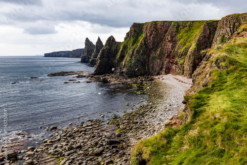 Duncansby Stacks, a breathtaking coastal wonder in Scotland, rise dramatically from the North Sea. Standing atop the towering cliffs, visitors are rewarded with panoramic ocean views, rugged landscape
