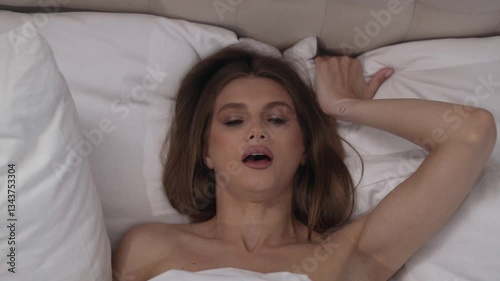 Intimate pleasure of a woman in bed