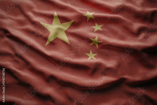 A close up of a red and yellow flag with stars