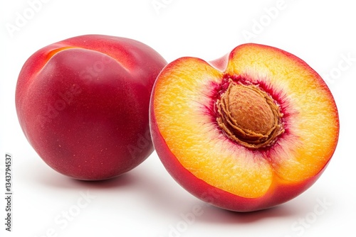 Fresh peaches displayed on a white background with one whole and one sliced revealing juicy flesh photo