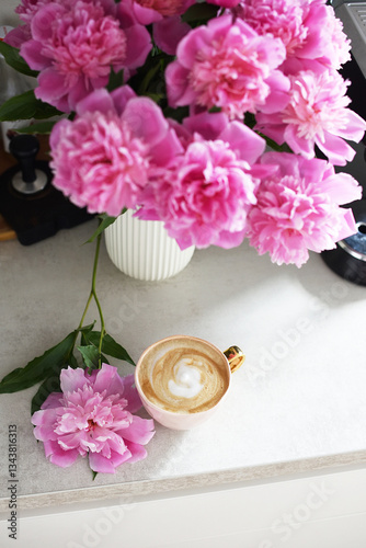 Cup with cappuccino, flowers peony, morning concept, woman's day