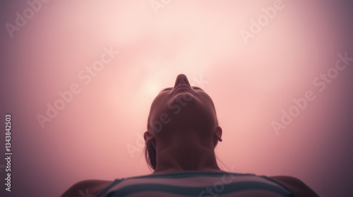 Woman Looking Up in Serene Light with Emotional Depth photo