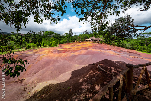 Scenic and beautiful view of amazingly colorful eroded dunes in a tropical jungle clearing at the Seven Colored Earth Geopark in Chamarel, Mauritius