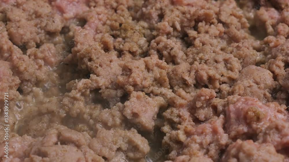 Minced veal is fried in a frying pan in vegetable oil. Medium shot. Minced veal is fried in a frying pan in vegetable oil. Medium shot.