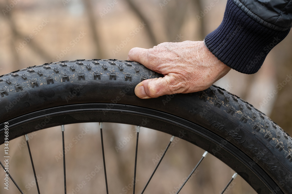 Fototapeta premium Bicycle wheel tire close-up.A bicycle tire with a large tread in the dried mud after a ride.