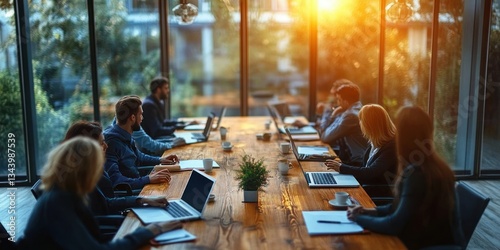 Top View of Busy Professionals Collaborating in Modern Office Meeting Room with Laptops and Coffee