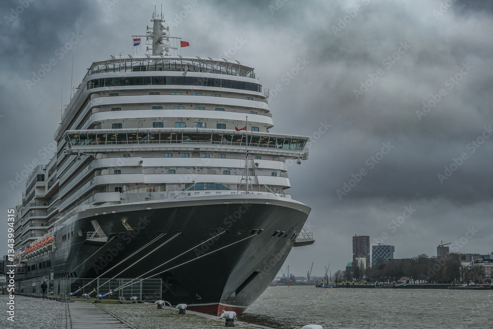 Brand new ocean liner cruiseship cruise ship Queen Anne in port of Rotterdam, Holland with skyscraper downtown city skyline