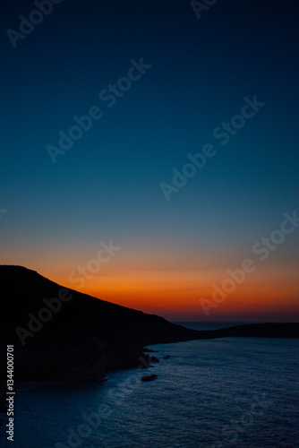 Sunset in a bay near Sitia, Crete, where the last colors of the day are reflected in the sea