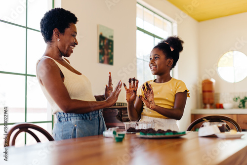Happy brazilian family making brigadeiro: Mother and daughter bonding in the kitchen