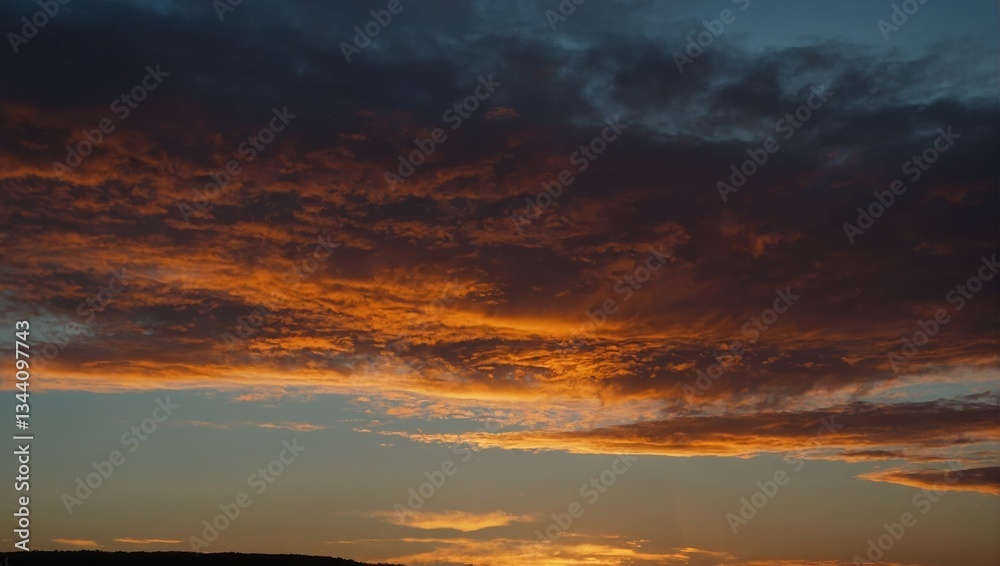 Fototapeta premium Striking Sunset Panorama: Fiery Clouds and Tranquil Sky in a Dramatic Sky-scape