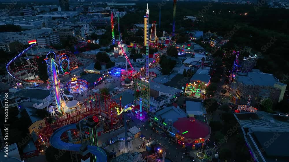 Aerial view fun fair. Twilight time illumination Vienna city famous theme amusement park Prater riverside downtown aerial panorama 4k Austria