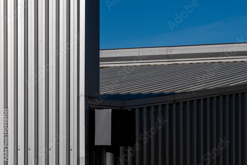 Wallpaper Mural Metallic facade of a warehouse building with strong linear composition. A study in symmetry, texture, and industrial aesthetics in contemporary architecture. Torontodigital.ca