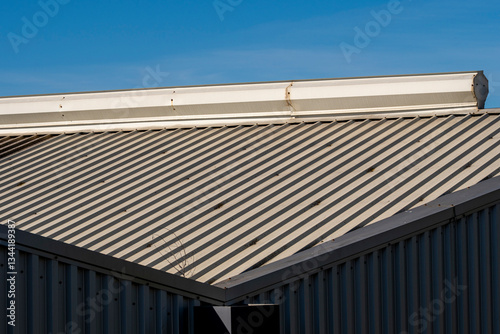 Wallpaper Mural Industrial roof detail with a sharp geometric structure under a blue sky. A minimalistic composition capturing the essence of industrial and modern design. Torontodigital.ca