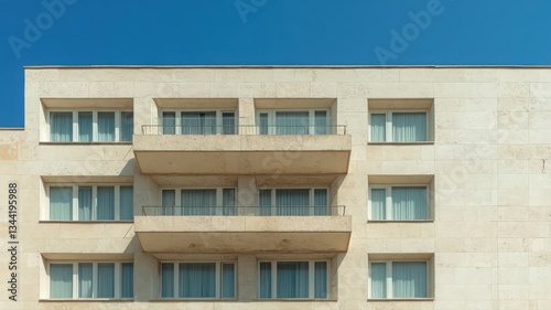 Obraz na płótnie Beige Building Exterior with Balconies Under a Clear Blue Sky w salonie