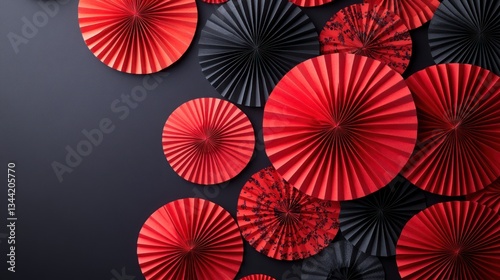 Red and black paper fans, decorative background, dark gray surface