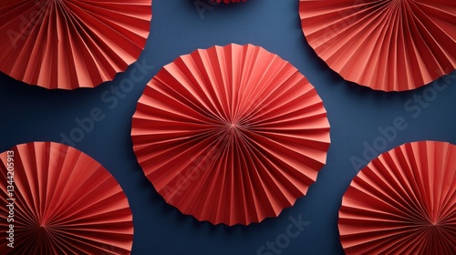 Red paper fans on dark blue background
