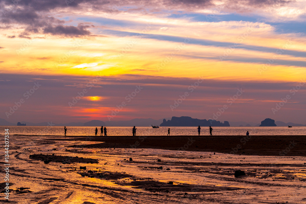 tourist watching sunset or sunrise on beach with seascape and gold lighting sunset sky background