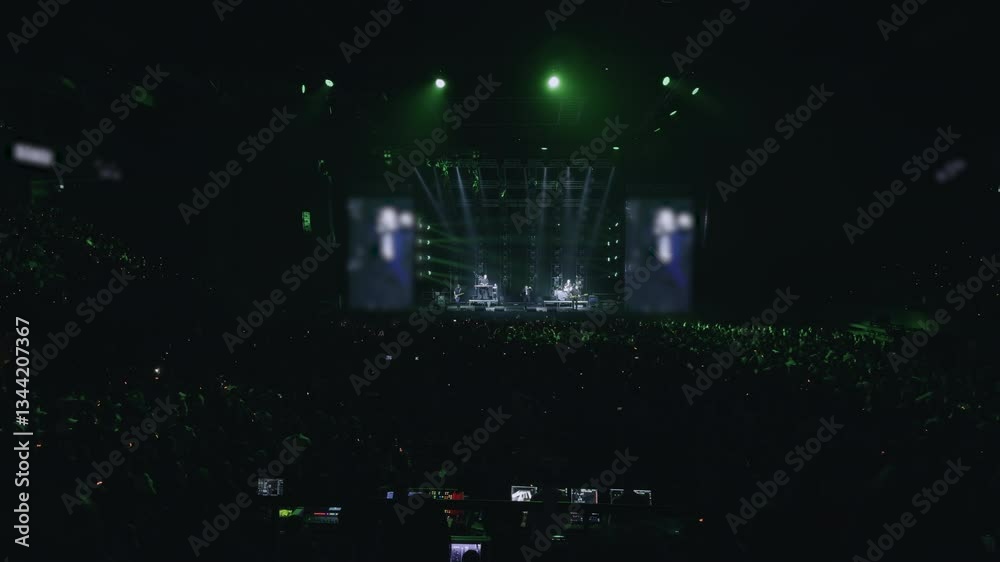 Several artists organized a grand concert for their fans. Huge hall filled with thousands of people. Incendiary atmosphere, various spotlights, smoke and large screens. Lights from phones Several artists organized a grand concert for their fans. Huge hall filled with thousands of people. Incendiary atmosphere, various spotlights, smoke and large screens. Lights from phones