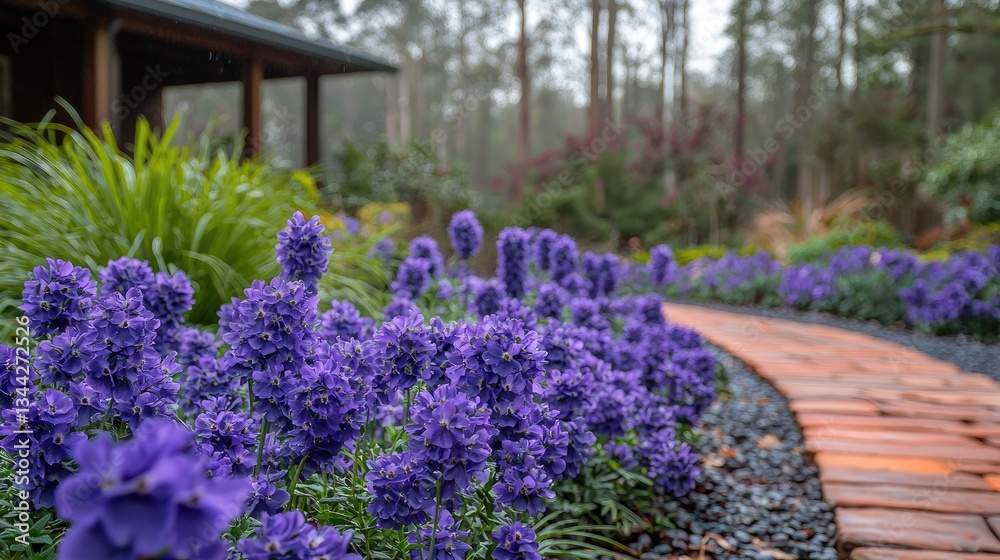 Obraz premium Vibrant purple flowers lining a winding brick path in a serene garden setting